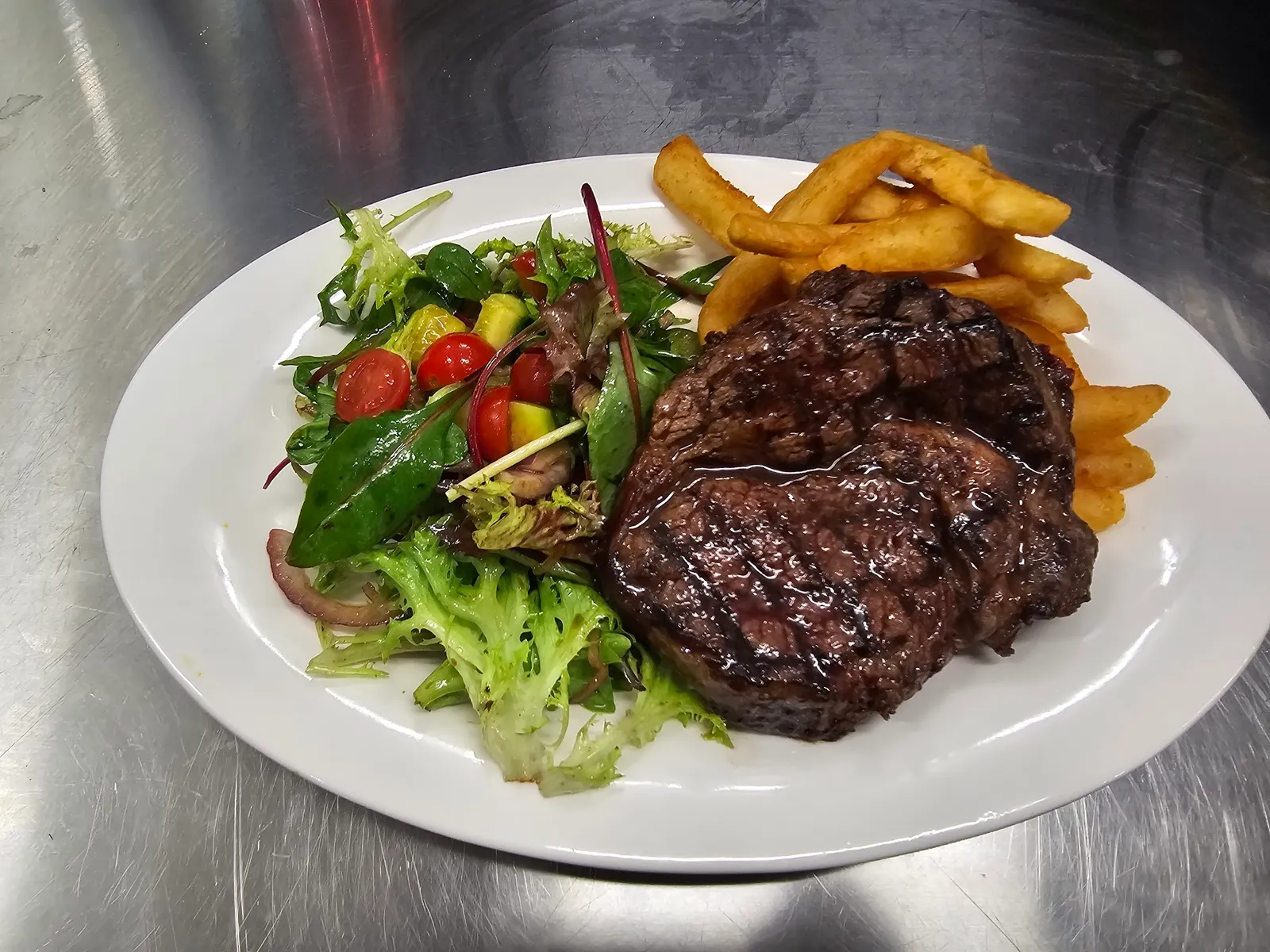 Grilled steak with salad and chips