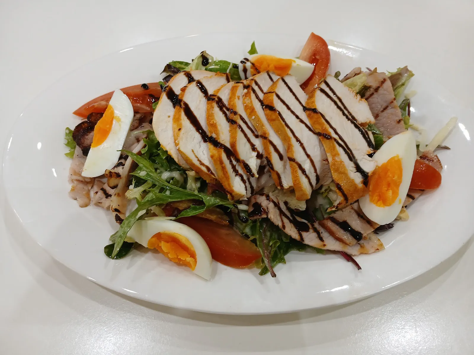 Grilled chicken salad with balsamic glaze