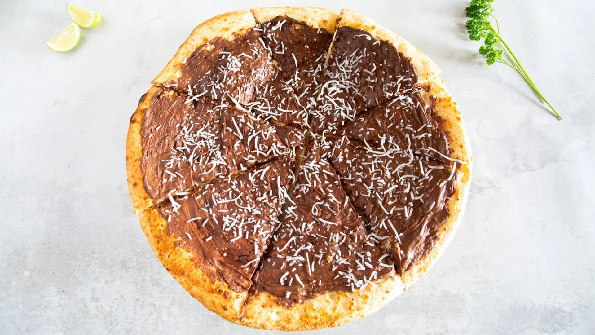 Nutella pizza with coconut shreds overhead