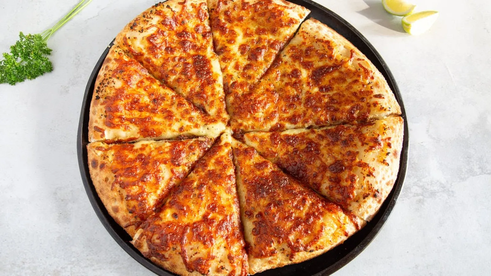 Classic cheese pizza on dark tray